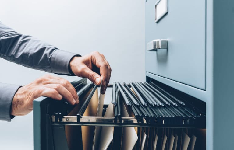 A person filing through records. Record-keeping.
