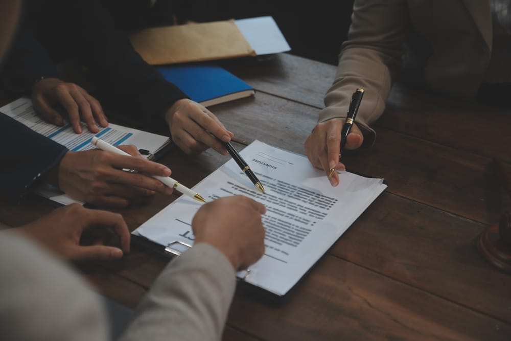 People looking at a piece of paper - The Worker Protection Act 2023 (Amendment of the Equality Act 2010)