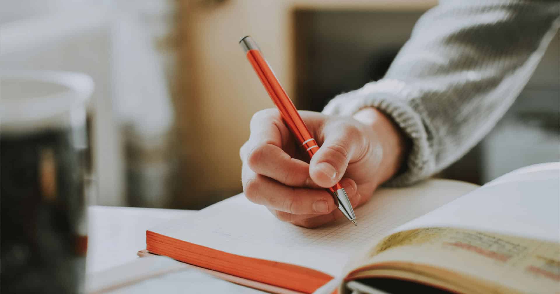 person writing in a notebook